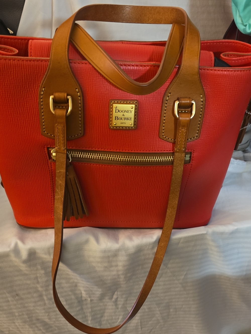 Dooney & Bourke bright red leather tote with tan trim and tassel